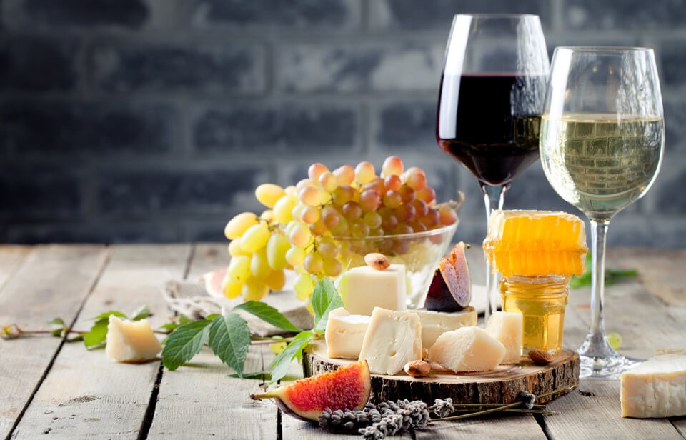 Grapes, cheeses and glasses of wine