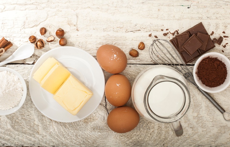 Butter and other baking ingredients on a wooden counter. 